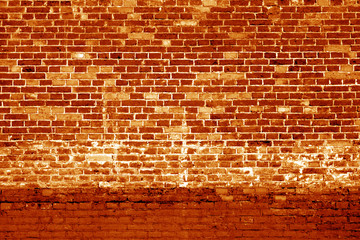 Fototapeta na wymiar Weathered brick wall background in orange tone.