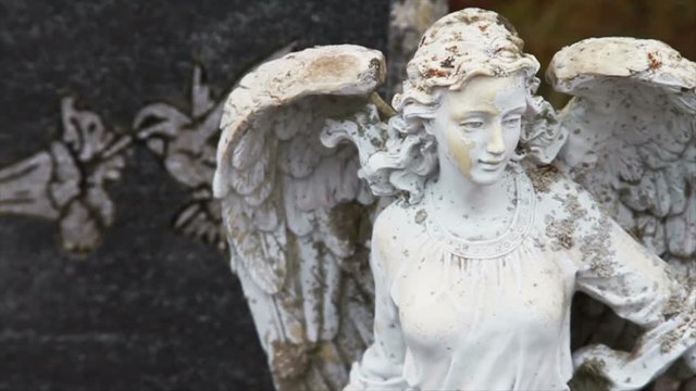 1111 Stone Angel Next to Grave Stone