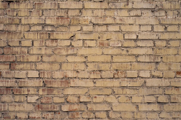 Old brickwork painted in yellowish color - retro background