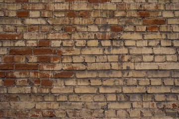 Old brick wall with the remains of paint - a retro background