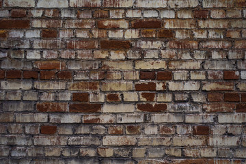 Old brick wall with the remains of paint - a retro background