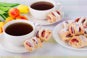 Strawberry pastries and coffee with flowers in background