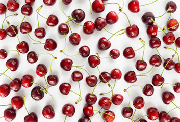 Fototapeta na wymiar Fresh red cherries lay on white isolated background with copy space. Background of cherries. Ripe cherry on a white background. Cherries with copy space for text. Top view. Cherry fruit.
