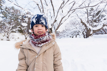 Fototapeta na wymiar Cute asian boy in winter
