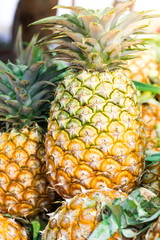 Pineapple background/ lots of ripe yellow pineapples/ market asia fruit food pineaple tomato vegetables street