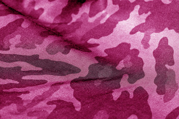 Military uniform pattern with blur effect in pink tone.