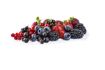 Set of fresh fruits and berries. Mix berries isolated on a white. Ripe blueberries, blackberries, currants and strawberries. Berries and fruits with copy space for text. 