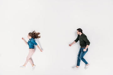 Fototapeta na wymiar top view of man and woman pretending to walk isolated on white