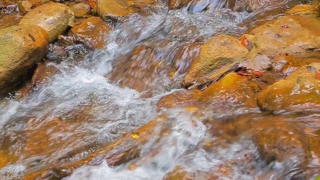 water washes the stones. Slow motion.