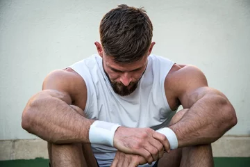 Zelfklevend Fotobehang Tired athletic man looking down after intensive fitness workout. © Bojan