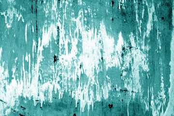 Weathered painted metal wall in cyan color.