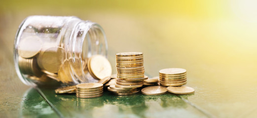 Money savings, save concept - web banner of gold coins with a jar glass