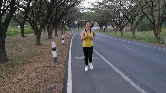 4k of fitness woman running in the park