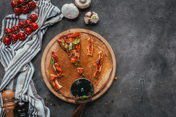 top view of pieces of eaten pizza with cutter on concrete table