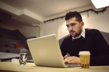 Young man using laptop computer.