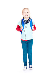 Portrait of little girl with earphones walking to school
