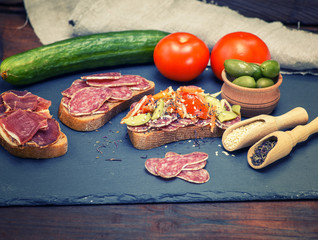 sandwiches with pieces of sausage salami and a hamon