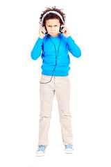 Portrait of cute curly-haired Latin American boy annoyed with music in his headphones