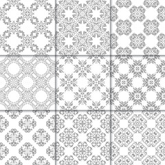 Gray and white floral ornaments. Collection of seamless patterns