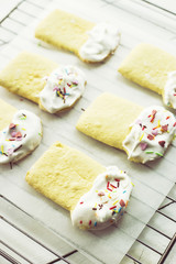 Cookies in the form of Easter cakes, decorated with whipped whites with a multicolored powder. Easter dishes and decorations. Holiday spring concept