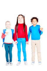 Fototapeta premium Portrait of three multi-ethnic school friends holding hands on white background