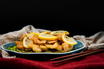 Chinese food fried fish and lemon slices