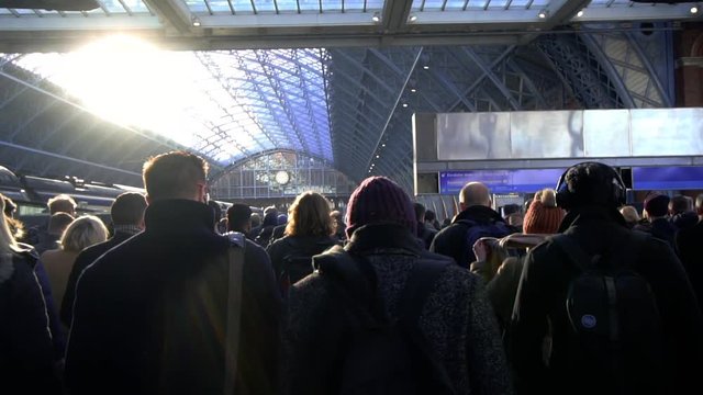 Railway commuters walking down platform in London