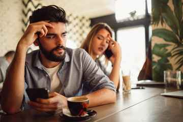 Offended couple man and woman looking sad and disappointed after quarrel concerning family life.