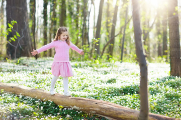 Child in spring park with flowers