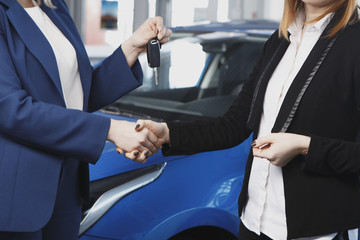 Handover of car keys in a dealership