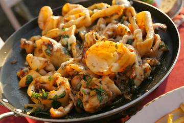 Fried squid rings in pan, restaurant Croatia.
