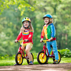 Fototapeta premium Kids ride balance bike in park