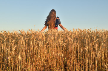 The girl stands in the back of the field to the camera