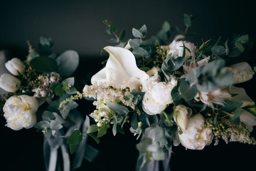 Beautiful wedding bouquets of the bride and girlfriend of the bride on a dark background