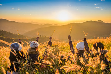 Obraz premium Girl group friend arms up enjoy on mountain sunrise.