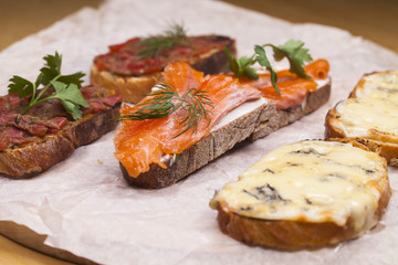 Fototapeta na wymiar Toasted toast with salmon and cheese