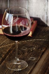Glass of red wine on a wooden table   