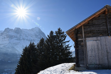 Wooden barn and Eiger at a winter day, Grindelwald, Switzerland