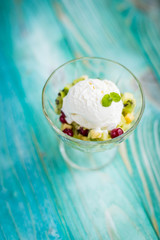 fruit salad with ice cream on a blue background