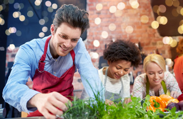 happy friends cooking and decorating dishes