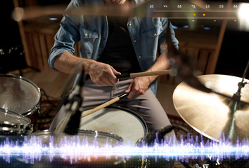 drummer playing drum kit at sound recording studio