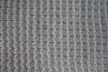 White handmade knitted fabric texture from above