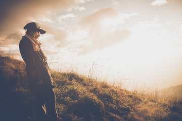 Beautiful woman standing on mountain with blue sky.