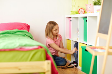 girl with schoolbag at home