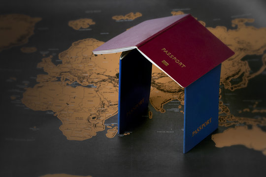 passports in the form of a house lie on the map, conceptual photo, travel
