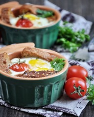 For breakfast, egg with bread and whole tomatoes cherry baked in oven molds