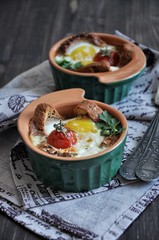 For breakfast, egg with bread and whole tomatoes cherry baked in oven molds
