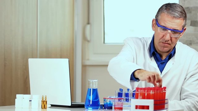 Scientist Typing on Laptop Computer in Biochemistry Lab