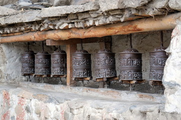An ancient religious Buddhist prayer drums on the street. Upper Mustang. Nepal.
