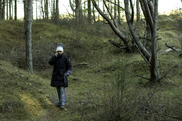 woman on mobile phone in wood walk